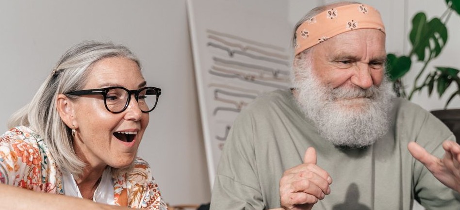 Two older adults enjoying a video game