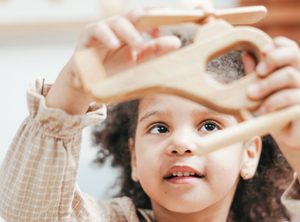 Girl playing with toy helicopter