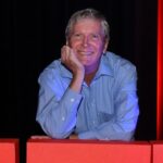 Jim Barber, leaning on TEDx logo